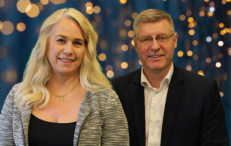 Peter Nordberg and his wife Lise-Lotte smiling together in front of warm bokeh lights